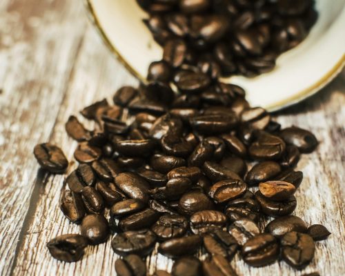 coffee beans spilling from a large vessel